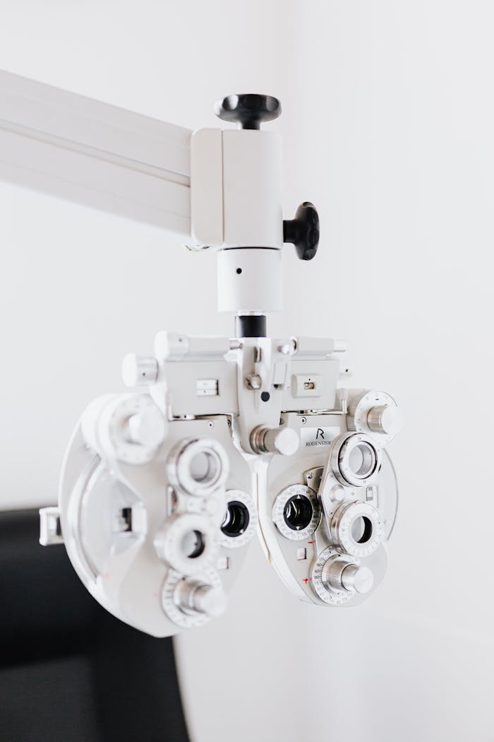 Close-up shot of a modern optical phoropter for eye examinations in a clinic setting.
